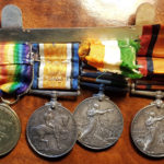 4 medals with reverse side showing