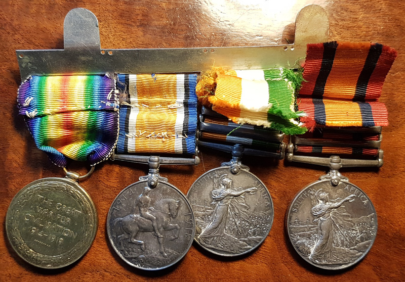 4 medals with reverse side showing