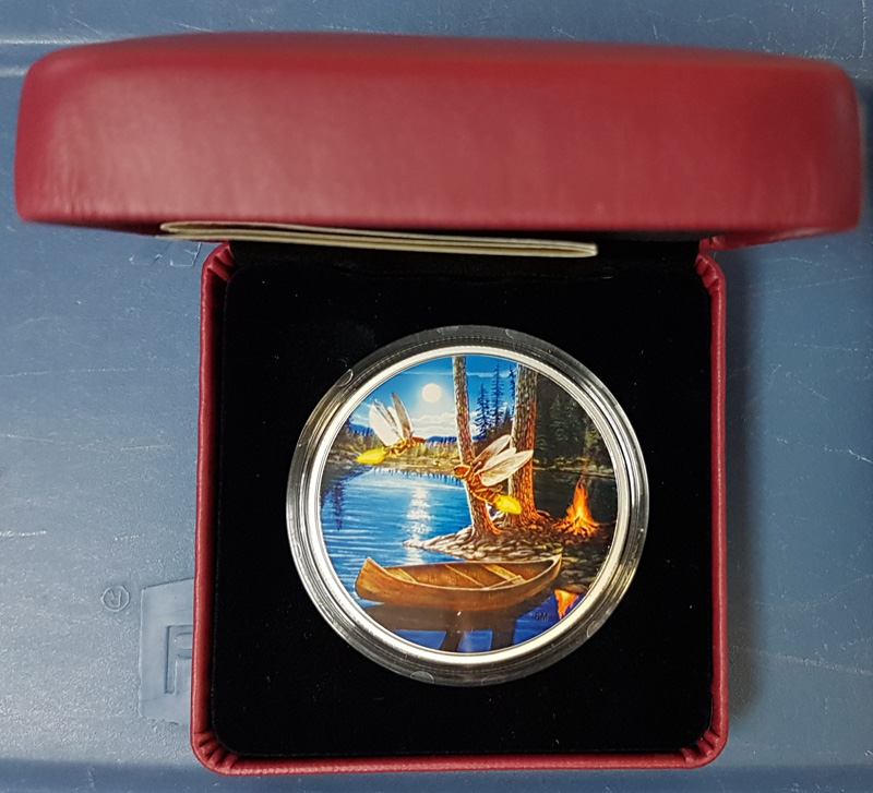 Fireflies colour coin in capsule in display case